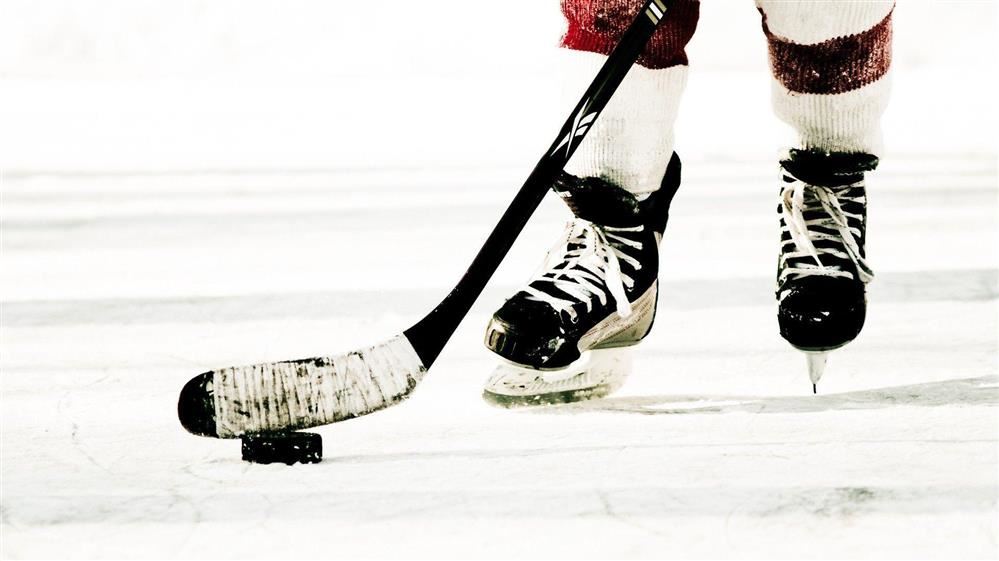  Photo of hockey puck and stick